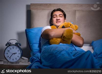 Young man sleeping in the bed