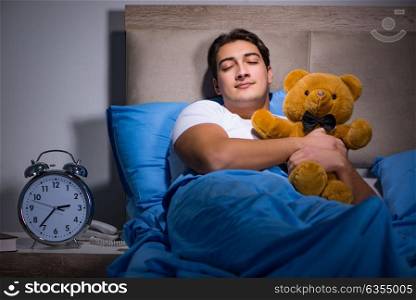 Young man sleeping in the bed