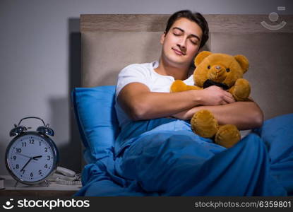 Young man sleeping in the bed