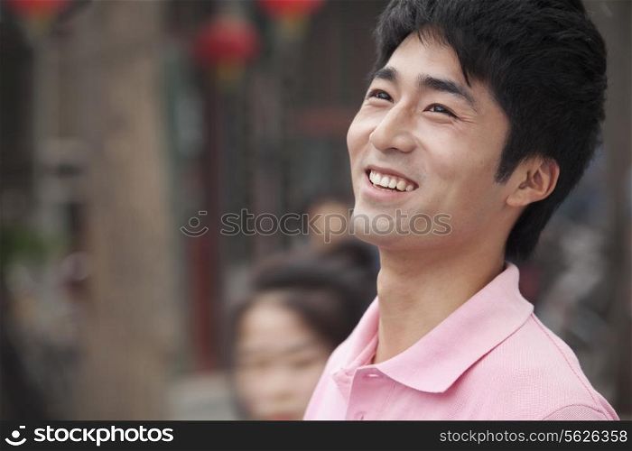 Young Man smiling and looking away