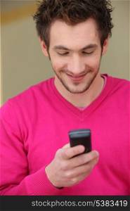 Young man smiling at his phone