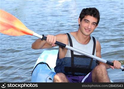 Young man smiling in a canoe