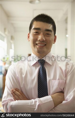 Young man smiling in the office, portrait