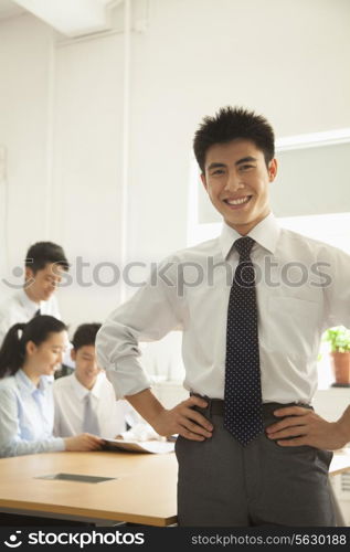 Young man smiling in the office, portrait