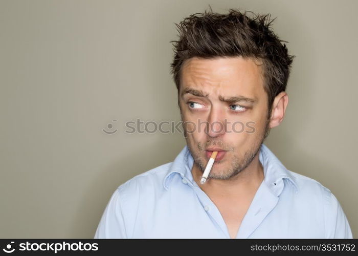 Young man smoking cigarette.