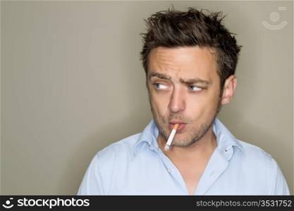 Young man smoking cigarette.