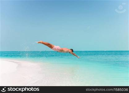 Young man snorkeling in clear tropical turquoise sea. Young man plunging into the turquoise sea