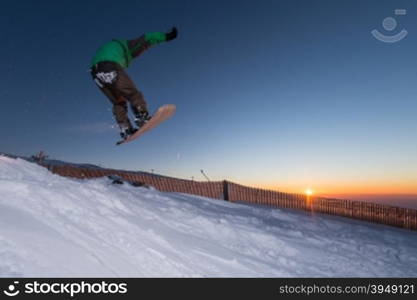 Young man snowboarding in the mountains.