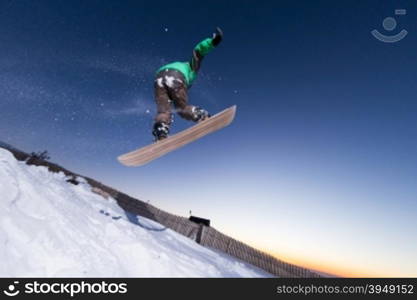 Young man snowboarding in the mountains.