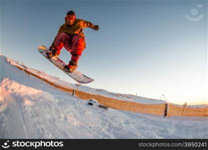 Young man snowboarding in the mountains.