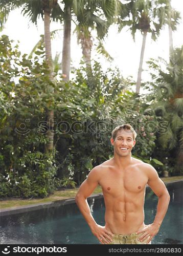 Young Man Standing at Swimming Pool