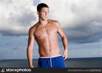 Young man standing bare chested