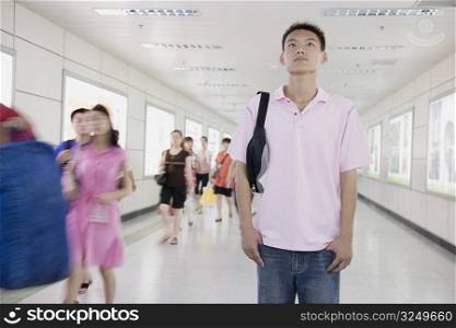 Young man standing in a corridor