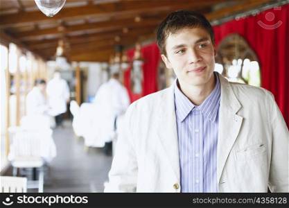 Young man standing in a restaurant