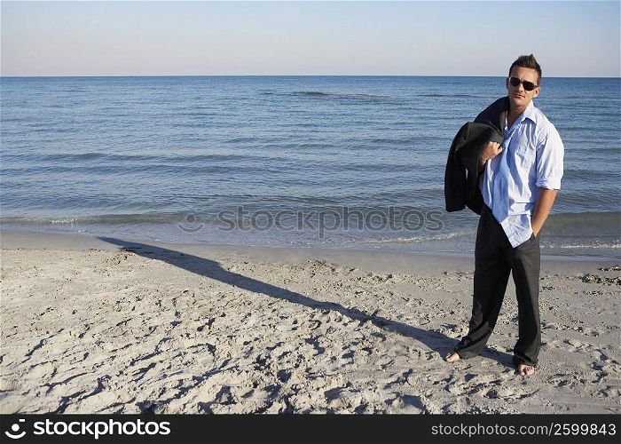 Young man standing on the beach