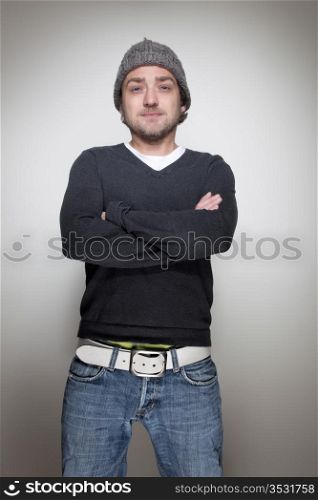 Young man standing with arms crossed