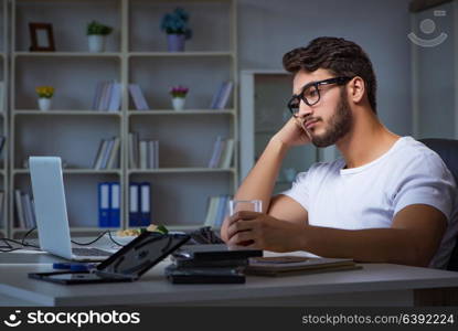 Young man staying late in office to do overtime work