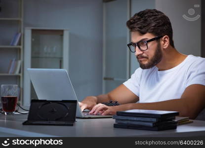 Young man staying late in office to do overtime work