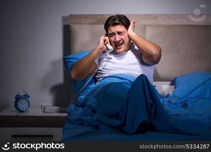 Young man struggling from noise in bed