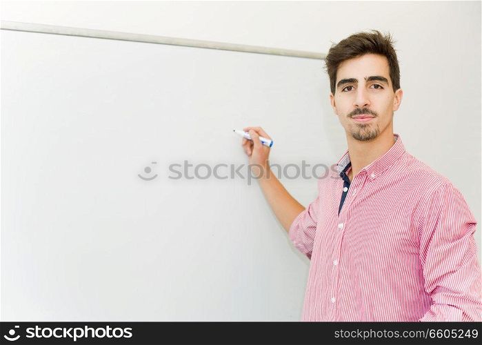 young man student at the school, on the whiteboard