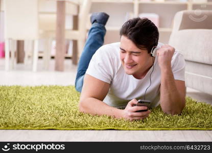 Young man student listening to music at home