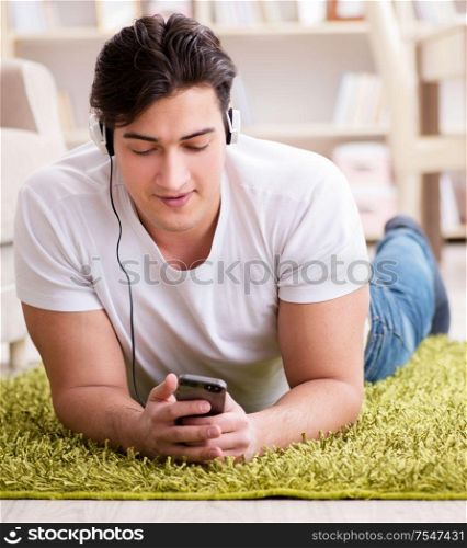 Young man student listening to music at home. The young man student listening to music at home