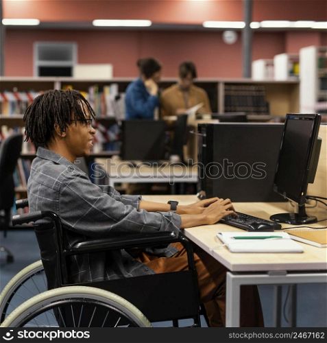 young man studying university library