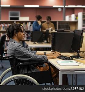 young man studying university library