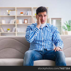 Young man suffering a neck spine head trauma wearing a cervical collar neck brace. Young man suffering a neck spine head trauma wearing a cervical