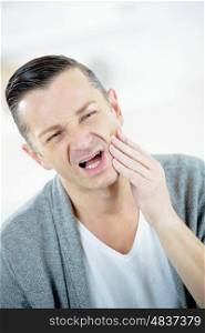 young man suffering from toothache