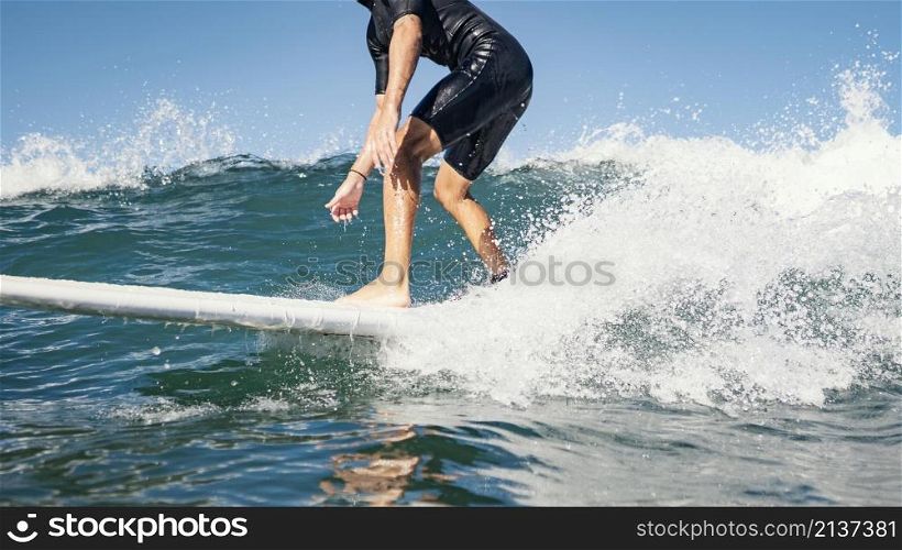 young man surfs ocean clear water waves
