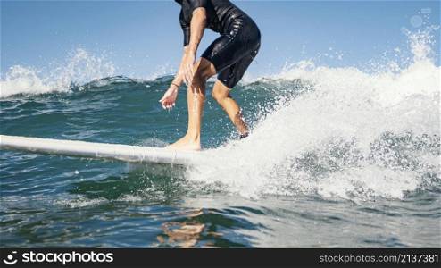 young man surfs ocean clear water waves
