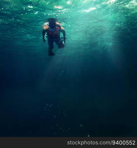 Young man swimming. Shot taken from below the water