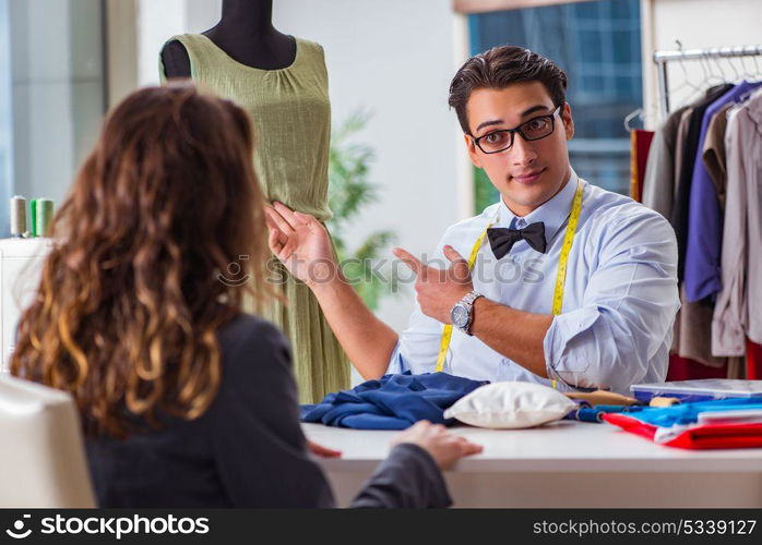 Young man tailor working with female client