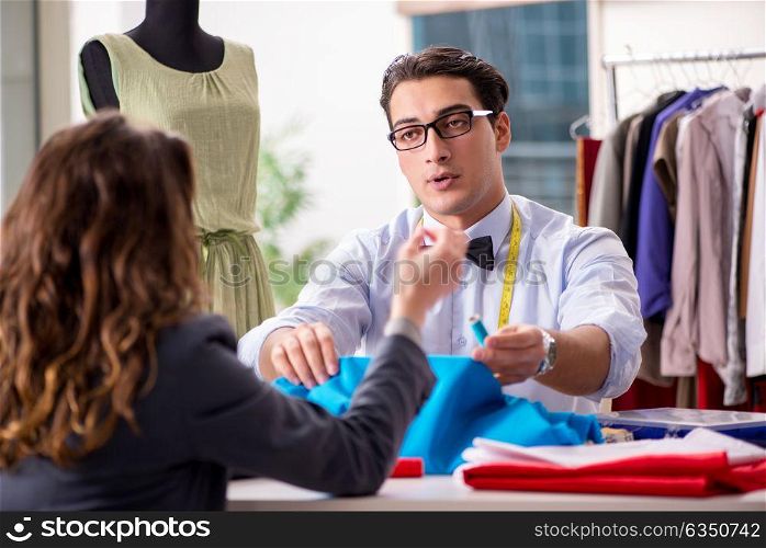 Young man tailor working with female client