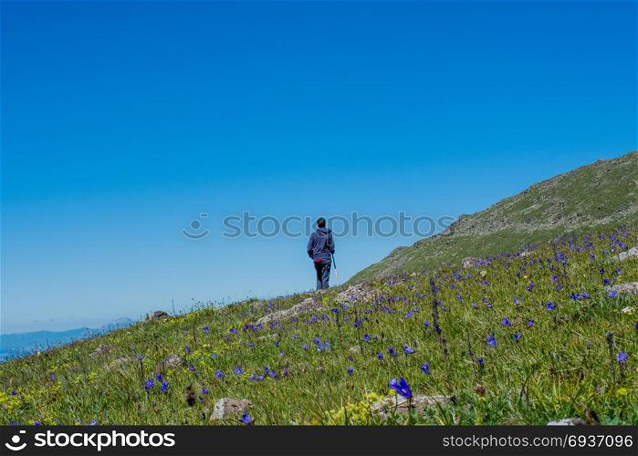 Young man taking an excursion on a mountain