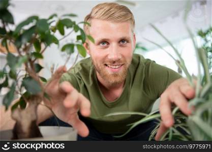 young man taking care of his plants