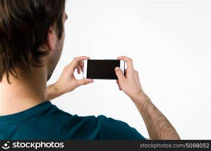 Young man taking selfie. Young handsome man taking selfie on mobile phone camera