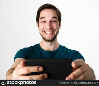 Young man taking selfie. Young handsome man taking selfie on mobile phone camera