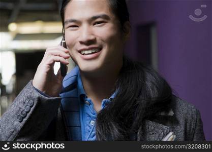 Young man talking on a mobile phone and smiling