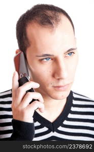 Young man talking on cellphone and worried with something, isolated on white background