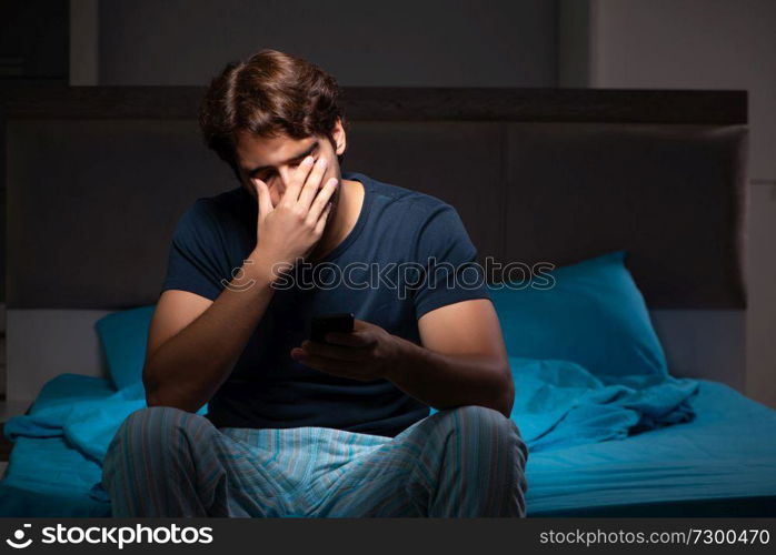 Young man talking on mobile late at night