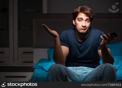 Young man talking on mobile late at night