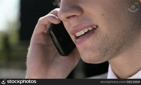 Young man talking on the telephone. Close-up