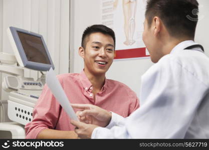 Young Man Talking With Doctor