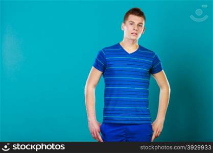 Young man teen boy portrait studio shot on blue background