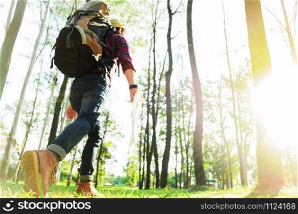 Young Man Traveler with backpack, are holding map relaxing outdoor on background Summer vacations and Lifestyle hiking concept.
