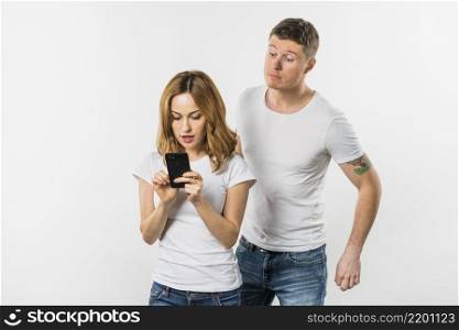 young man trying spy her girlfriend s mobile phone isolated white background