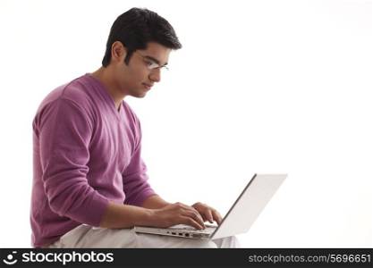 Young man typing on laptop