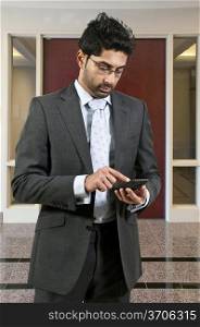 Young man using a cell phone for texting
